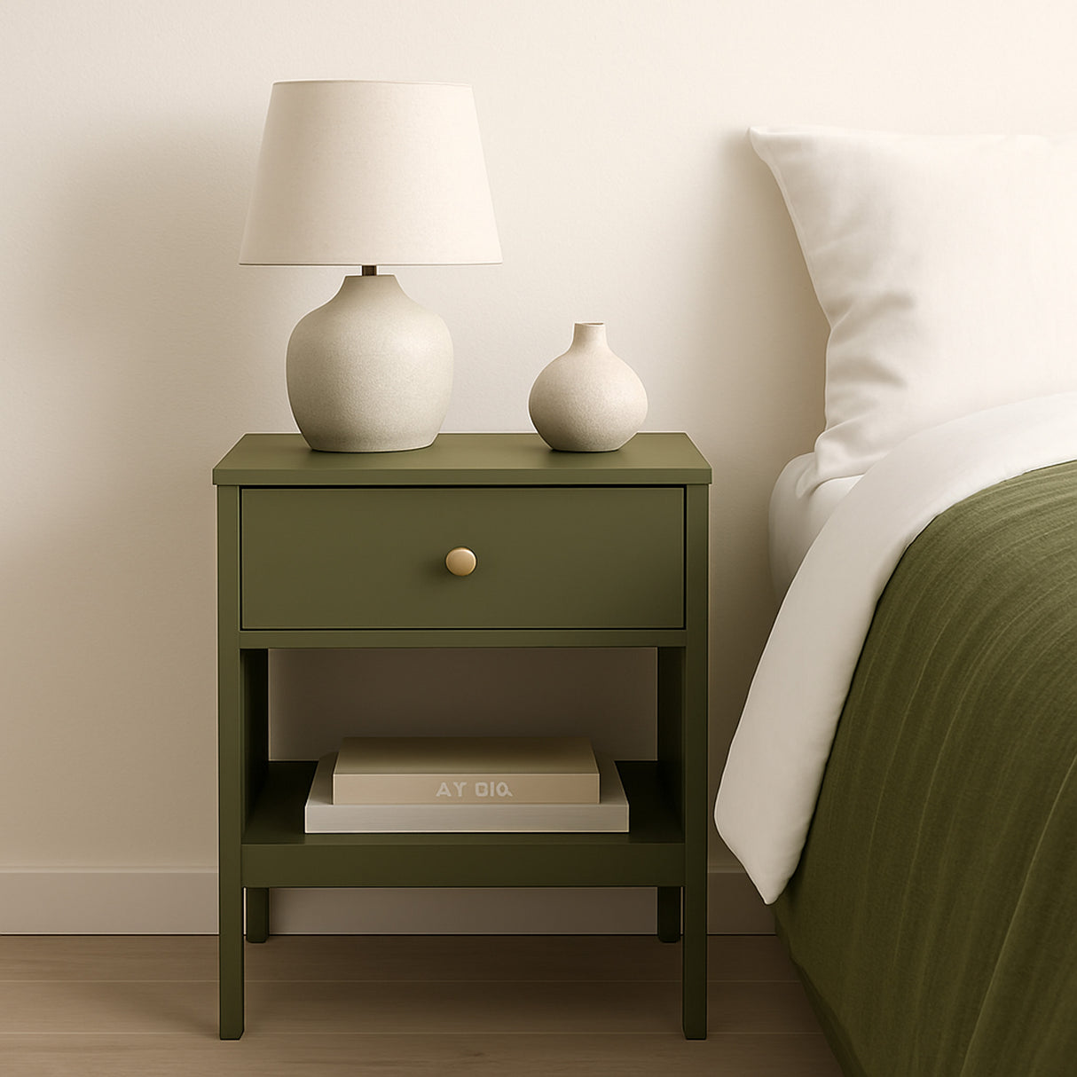 Nattbord med olivengrønn silkematt kontaktplast fra Lindas Dekor ved siden av en seng