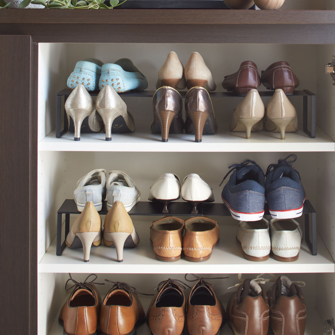 To sorte skohyller stablet med mange sko i gang