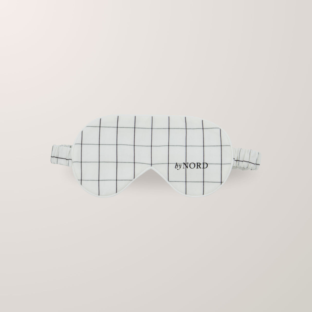 Sovemaske med ruter og elastisk stropp.