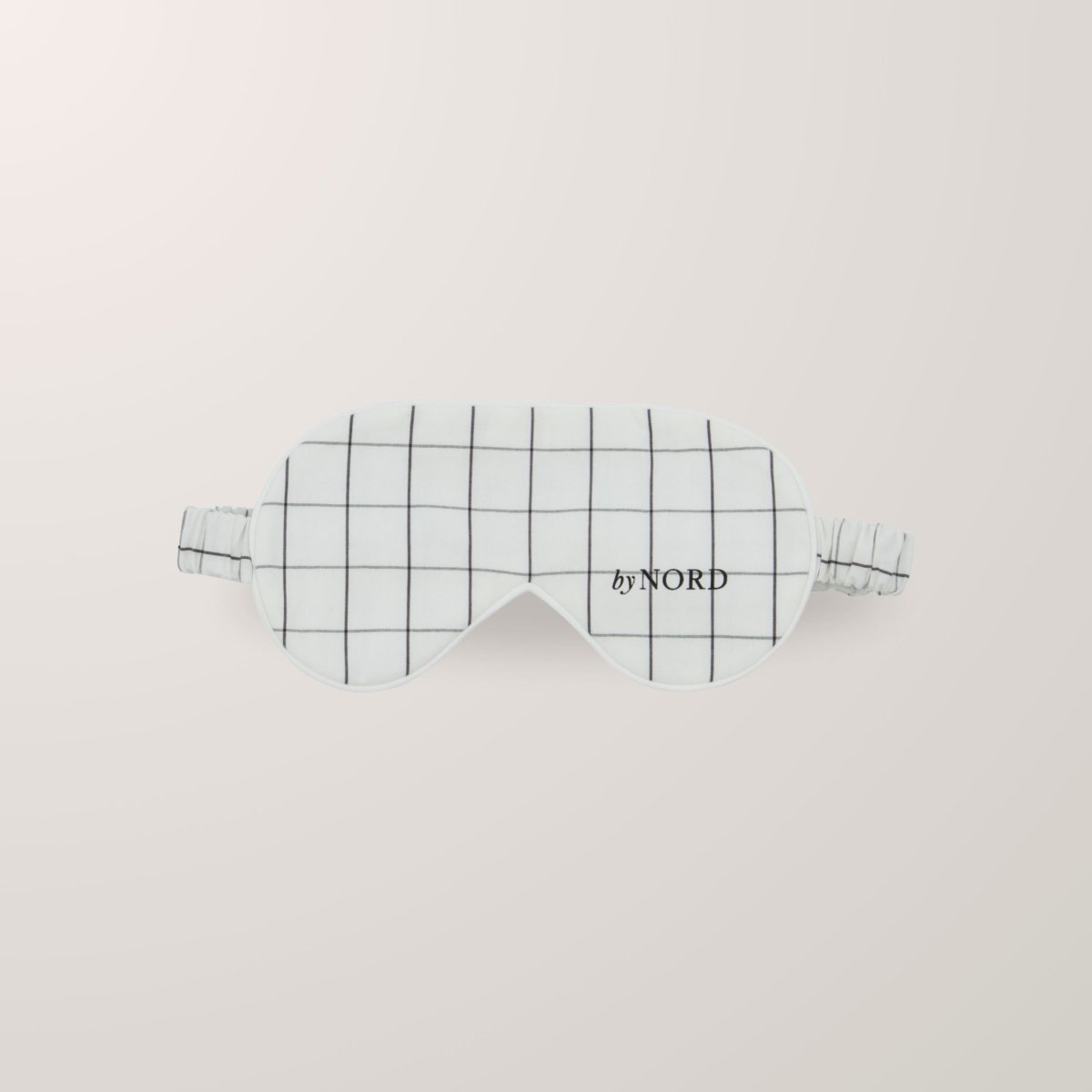 Sovmask med ruter och elastisk rem.