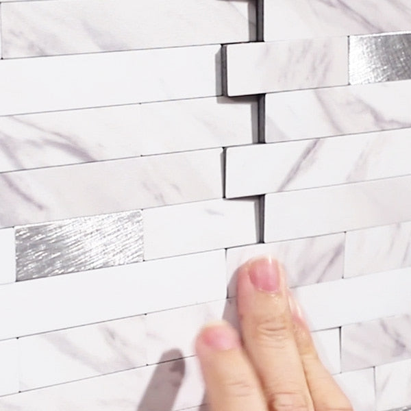 Elegant backsplash i marmorlook montert bak kjøkkenbenk.