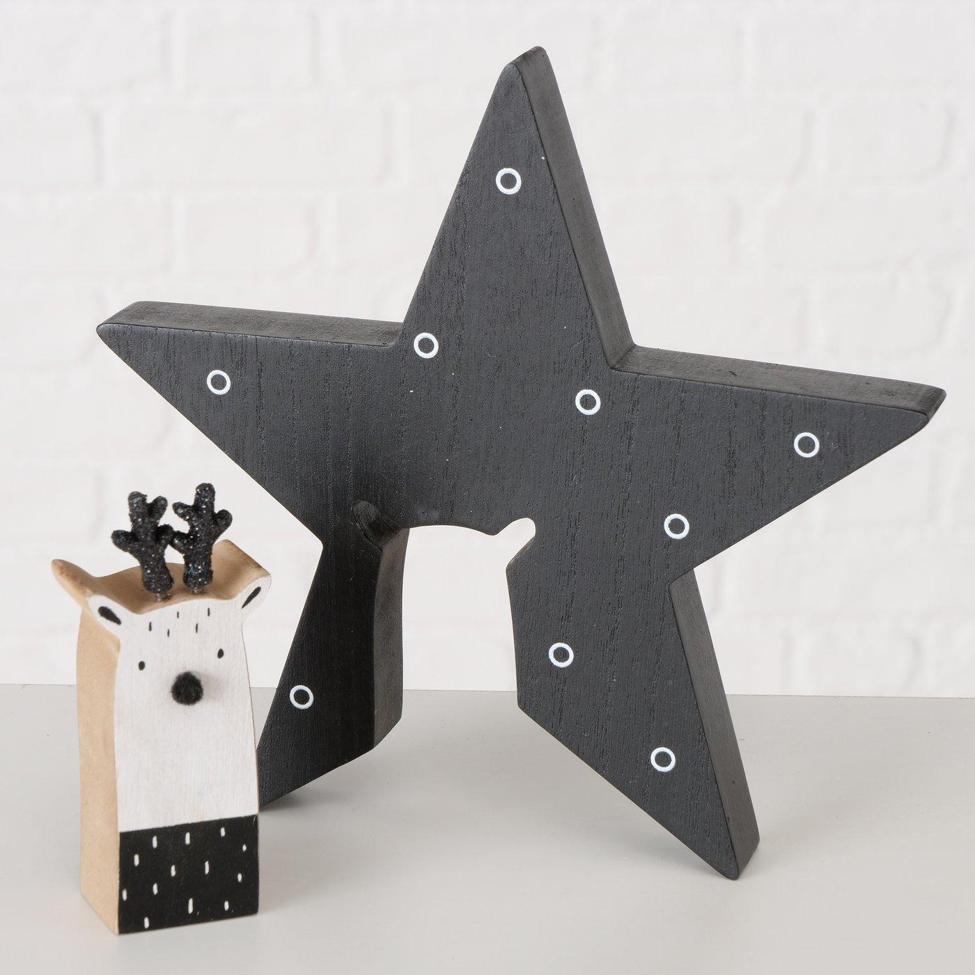 Nærbilde av Rudolf stjerne i sort tre med hvit detalj.