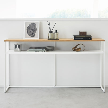 Detaljbilde av hvitt konsollbord med treplate i stue.