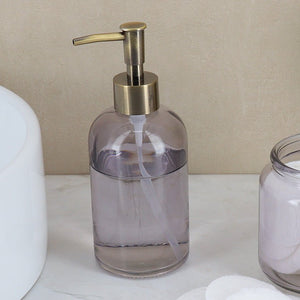 Glass sæbedispenser set fra siden med bronsefarget pumpe