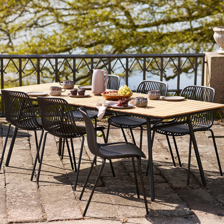 Sort spisestol med luftig ryggdesign til uteplass