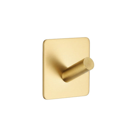 Självklibbande krok i guld till vägg