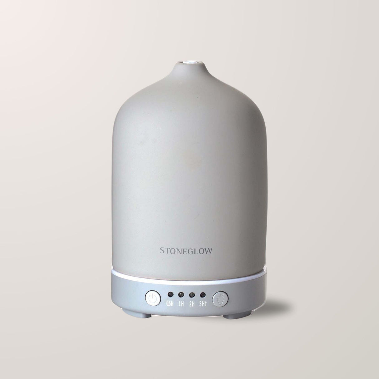 Grå elektrisk aroma diffuser med stilrent uttrykk mot blå bakgrunn.