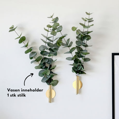 Realistisk kunstig plante med grønne blader på stuebord