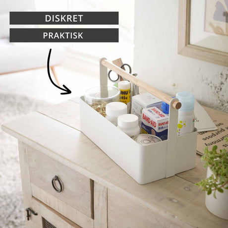 hvit metallboks med trehåndtak til organisering